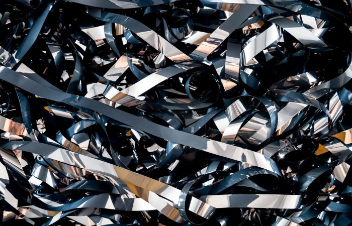A detailed close-up of tangled magnetic tape ribbons creating a complex abstract pattern.